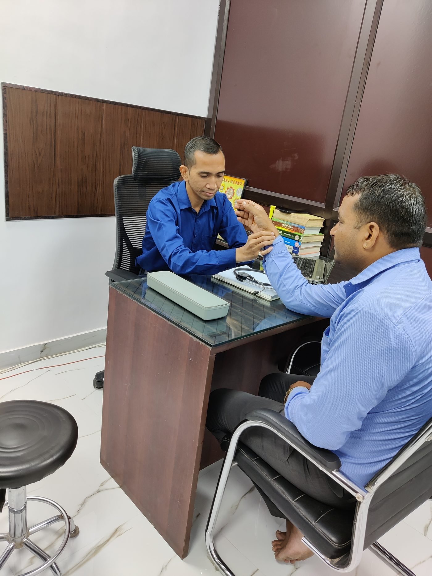 Dr. Hitendra Mankele conducting an Ayurvedic pulse consultation